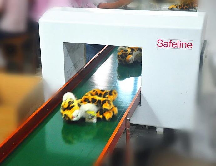 Metal detector quality inspection of finished plush toys before packing
